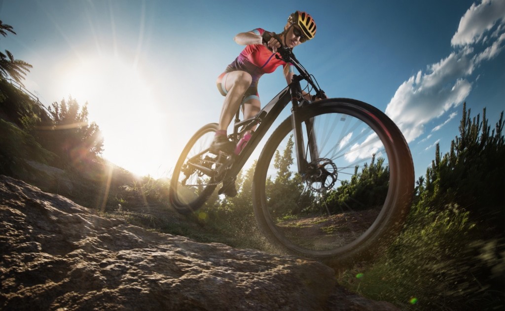 Sport. Mountain Bike cyclist riding single rock track.